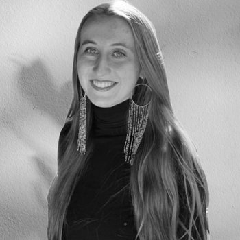 Leah smiling with long earrings on